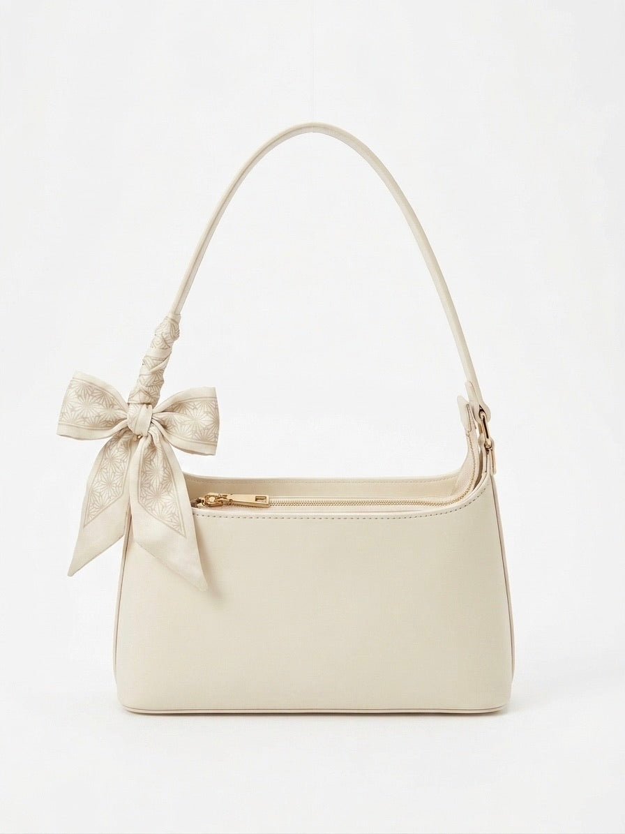 Sac à main blanc élégant aux détails doré et ruban assorti 